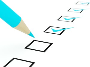 Checklist with blue pencil isolated on white